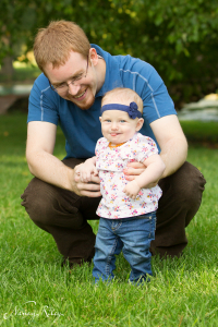 Father helping baby stand