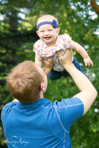 Daddy holding baby in air