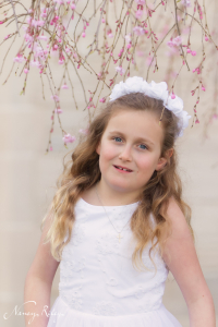 First Communion portrait with blooming trees