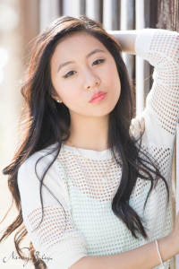 Senior leaning on striped wall