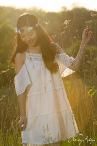 Boho senior portrait with sun flare