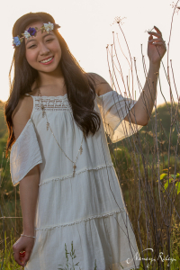 boho senior picture holding tall grass