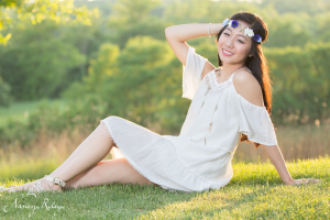boho senior picture sitting on grass
