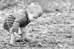 toddler digging stick in ground