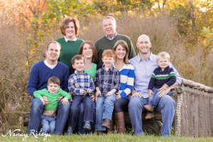 family on hillside bench