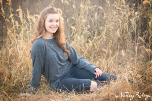 Senior sitting in field