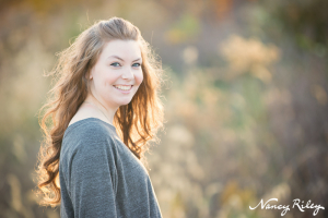 Senior sitting in field