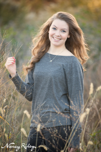 Senior standing in field