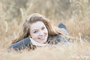 senior lying in grass