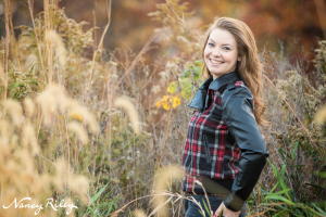 Senior standing in field