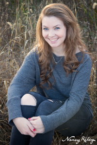 Senior sitting in field