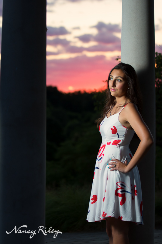 Senior with columns at sunset