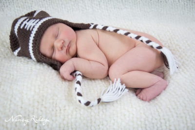 newborn in football hat