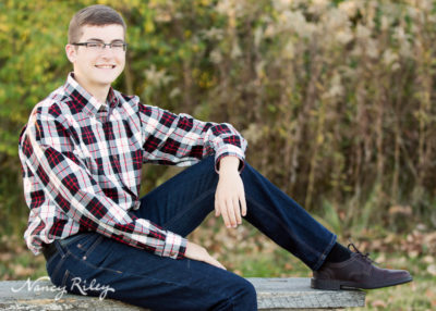 Senior boy seated on bench