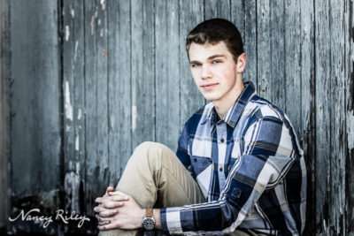 Senior boy with wood wall