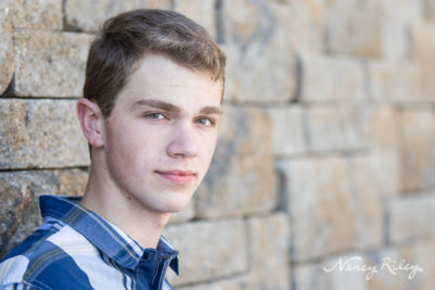 Senior boy with rock wall